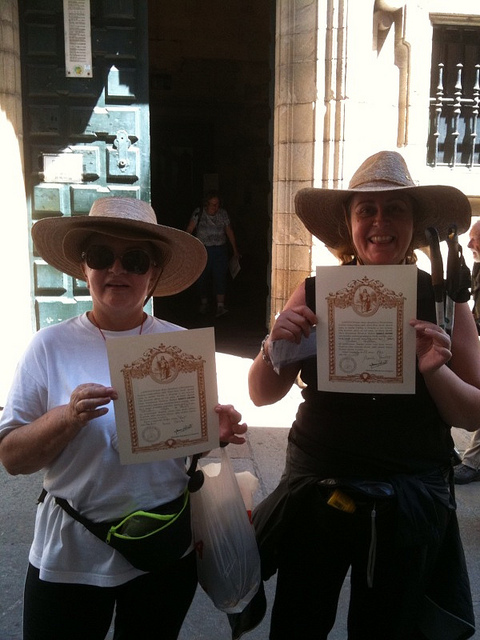 Dúas peregrinas recollendo a compostelana