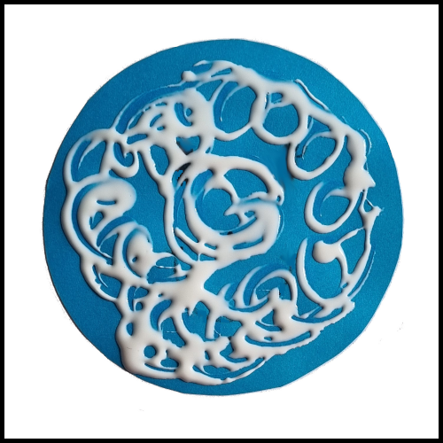 Put glue on the back of the coloured circle