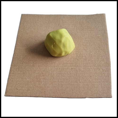 Paste a ball of dough on the cardboard