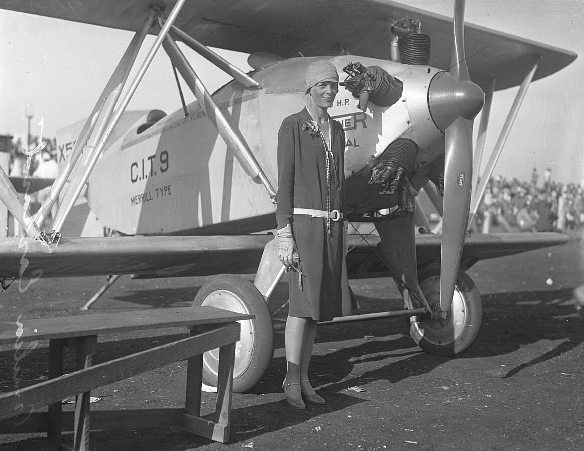 Amelia Earhart, standing beside a Safety Plane in 1928