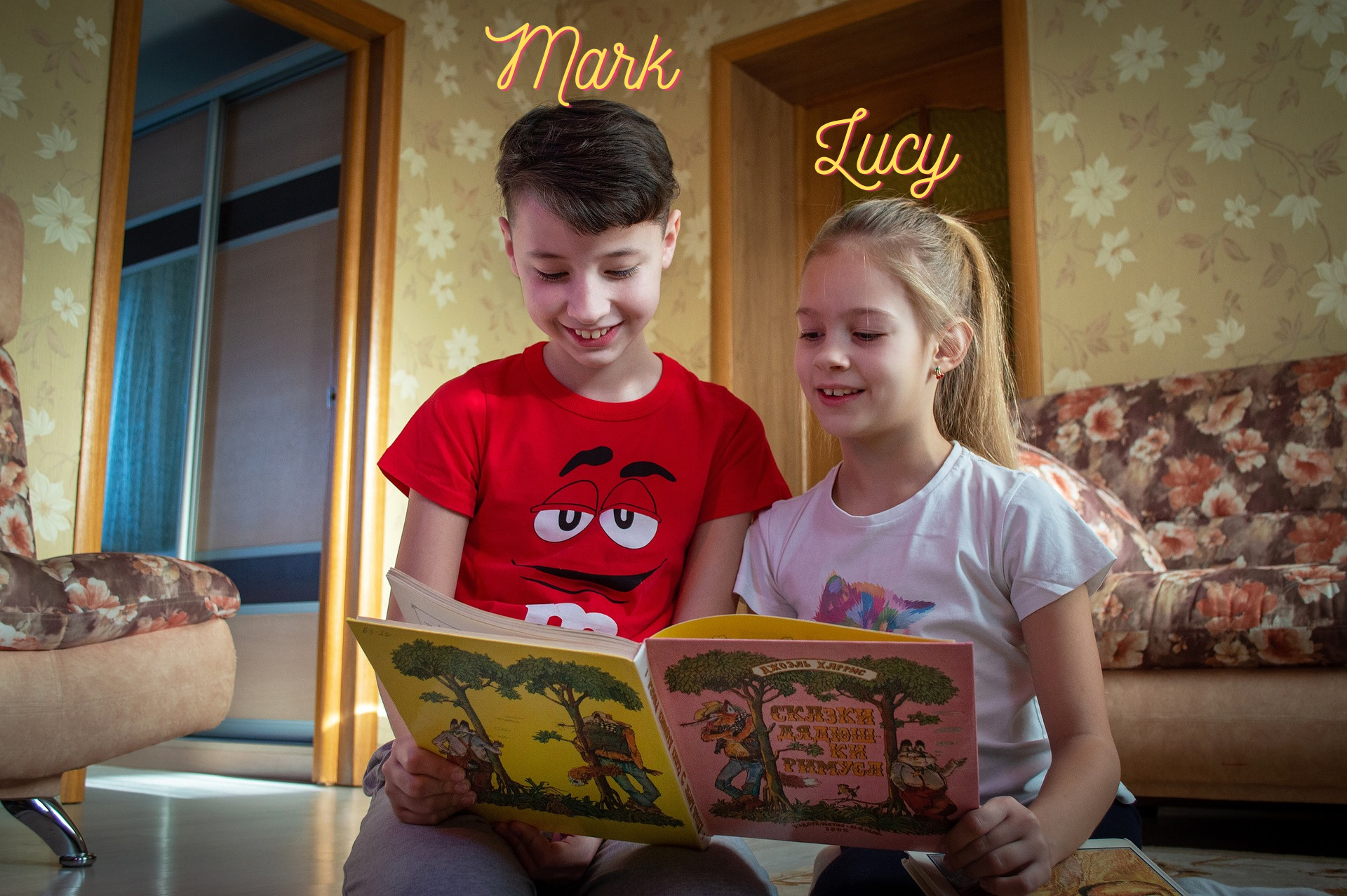 A boy and a girl reading a book.