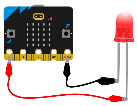 Imagen que muestra una placa microbit con unLED conectado al pin 0 y a GND