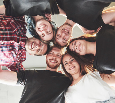 Imaxe que mostra un grupo de rapazas e rapaces abrazándose.