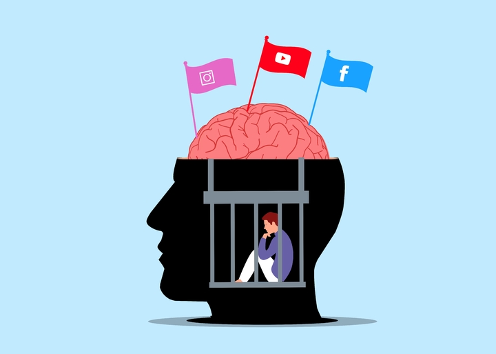 Ilustración de una cabeza humana dentro de la cual hay una persona encarcelada. Sobre el cerebro al aire de la cabeza tres banderas con los símbolos de Instagram, YouTube y Facebook.